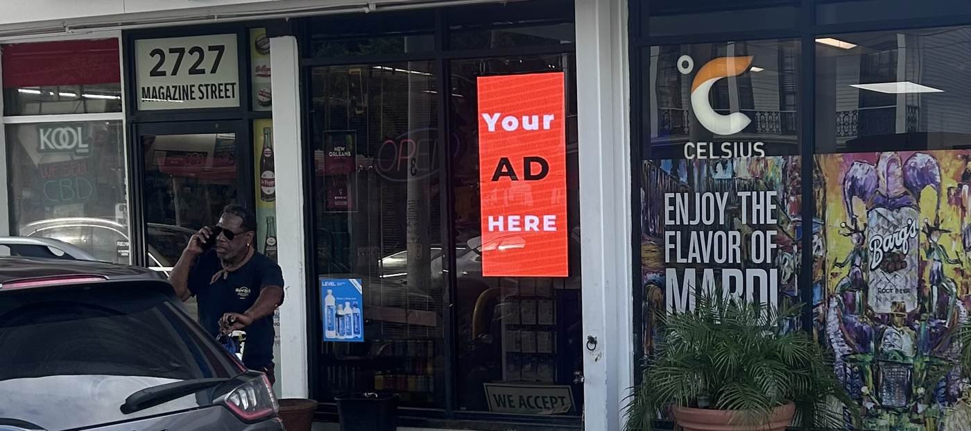 Hovertise LED screen in a storefront window on Magazine Street