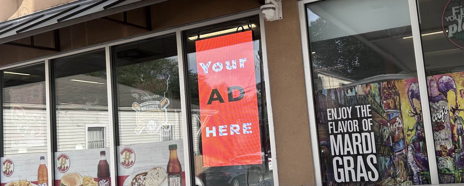 Hovertise LED screen glowing in a convenience store window in New Orleans